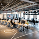 A shot of the open-floor concept at S23NYC, including computers at desks like a standard office but also a floor that resembles a basketball court